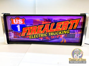 Illuminated sign: "US 1 Fire Alert! Electric Trucking" display for QEC
