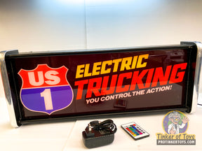 LED sign displaying "US 1 ELECTRIC TRUCKING YOU CONTROL THE ACTION!" with remote for QEC
