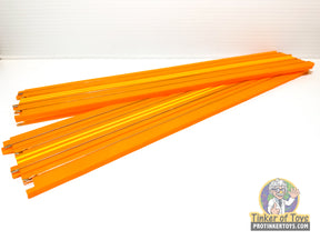 Orange drag track pieces for Hot Wheels, laid out on a white surface for Auto World SRS340