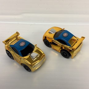Two gold stock car toys with blue and black accents for California Creations 20602, front view