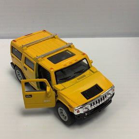 Yellow toy Hummer H2 SUV with open door, viewed from the side for Kinsmart 5337D