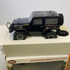 Black scale model of a Tarchee vehicle on a white surface for IMX IMX25055