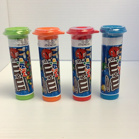 Four colorful, cylindrical candy containers lined up on a white surface for TOPPS 1411917