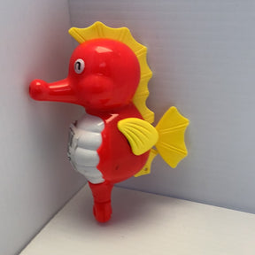 Red and yellow wind-up bath toy shaped like a cartoon fish for BVP 88537TY