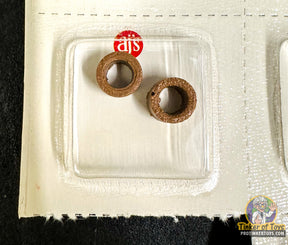 Two small, rusty-colored silicone train wheels on a white tray for AJ Inc 761 and762