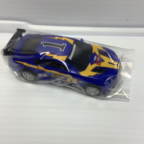 Slot car of a blue and yellow race car with "Johnny Lightning" decals for Johnny Lighting JL2011