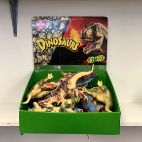 Green bin filled with soft, toy dinosaur figures for Schylling IMX49433