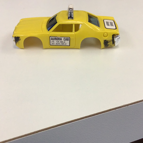 Yellow taxi body casting with "Aurora Cab" text on the side for Aurora / AFX / Tomy B1939Y