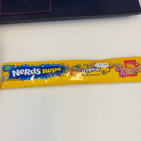 Yellow candy wrapper for Nerds Rope Tropical, featuring colorful candy illustrations for Nassau Candy 41560