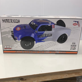 Blue 1/10 scale electric short course truck on its box for IMEX IMX22015