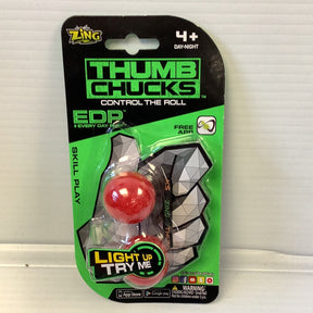 Toy packaging for Thumb Chucks, a skill-building game with a red ball and black pyramid for Zing ZG888CDU