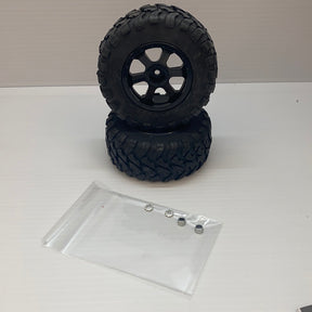 Stacked off-road tires and small metal hardware in a clear bag for IMX18468