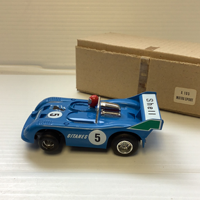 Blue slot car race car with "GITANES 5" on the side, next to a box for Polistil Evolution A.105