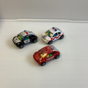 Three small, colorful toy cars filled with candy on a white surface for Nassau Candy 33030