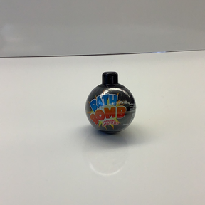 Black bath bomb with colorful "BATH BOMB" text on a white surface for Schylling BATHB