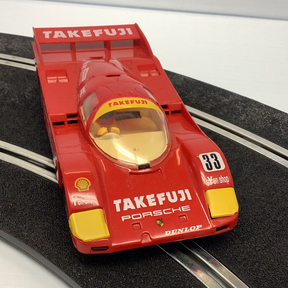 Red Porsche race car model, Takefuji #33, on a track for Scalextric C188