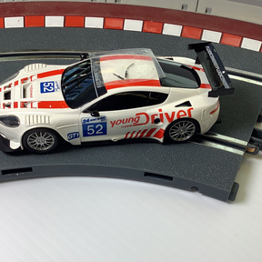 White race car model on a track section for SCX A10304X3U0