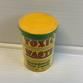 Yellow and red candy container labeled "Toxic Waste" sour candy for Nassau Candy 8887