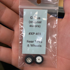 Tires and wheels for model vehicle, labeled XP 403, in clear packaging for G Plus