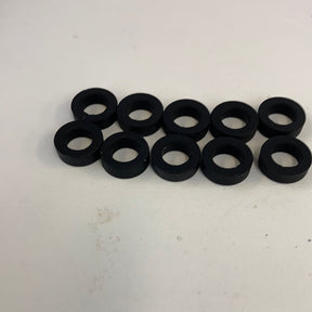 Ten black slot car front tires arranged in two rows for Auto World CP7906