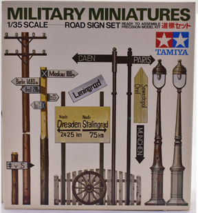 Scale model kit box art showing various historical road signs and street lamps for Tamiya MM167