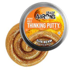 Yellow, glittery thinking putty in a metal tin for Crazy Aaron's SA003