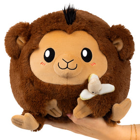 Brown stuffed monkey toy with black accents, held in a hand for Squishable SQU-115208