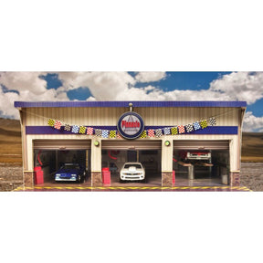 Model kit of a pit stop garage with three bays and cars inside for Innovative Hobby Supply BK6423