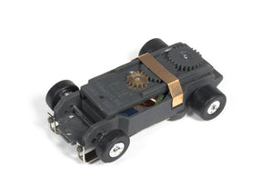 Black slot car chassis with wheels and visible mechanical components for Auto World PSCTJ-029