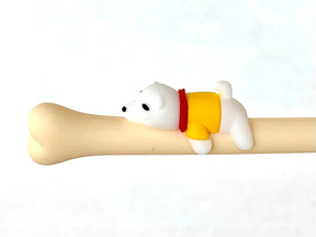 White puppy figure resting on a bone-shaped gel pen for BC Mini 22390