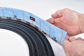 Hands holding race barrier material with printed graphics for AFX/Racemasters AFX22049