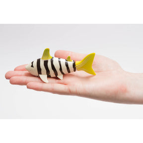 Shark toy on a hand, black and white stripes with yellow tail for Invento 500880