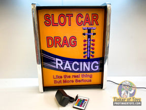 Neon sign reading "SLOT CAR DRAG RACING" with lights for QEC