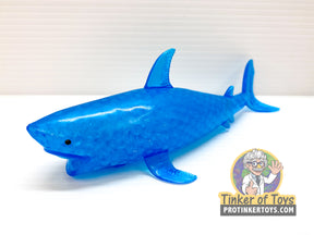 Bright blue, squishy shark toy resting on a white surface for BVP 87584