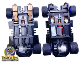 Two black robot chassis with visible motors and axles for building for Tyco